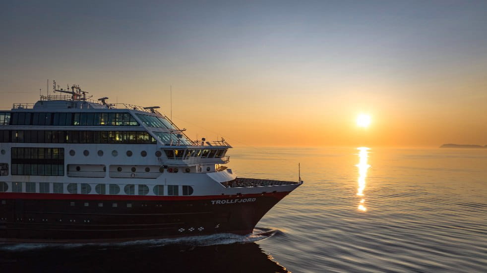 Hurtigruten ship MS Trollfjord at sea as the sun sets